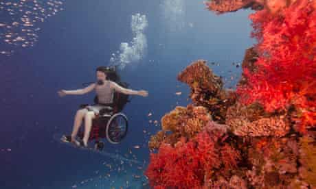 Sue Austin scuba diving in her electric wheelchair. Image: Guardian